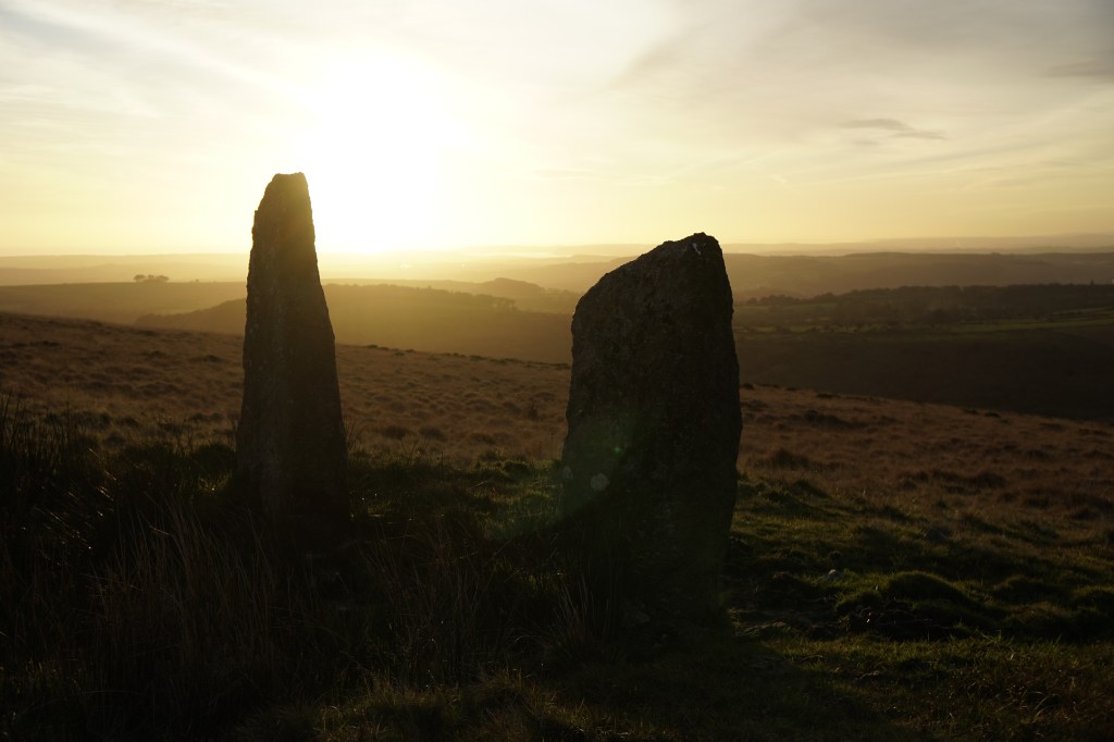 A view of a sunset between two standing stones